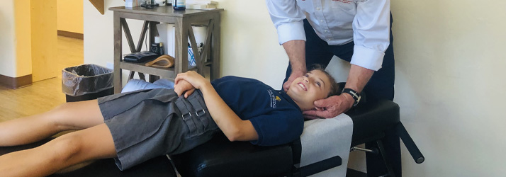 Chiropractor Oro Valley AZ Daniel Marsh Adjusting Child